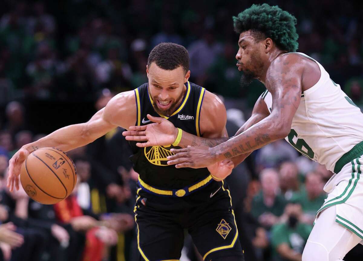 The Warriors’ Stephen Curry tries to get past the Celtics’ Marcus Smart in Game 3, won by Boston 116-100. Curry scored 31 points in the game and injured his left foot during a scramble in the fourth quarter.
