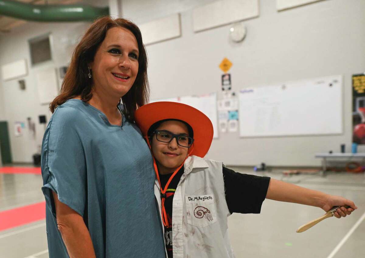 Jeanette Zuniga, a counselor at Maverick Elementary, poses for a picture in May with Matthew Arguello, a student who wants to be an archaeologist.