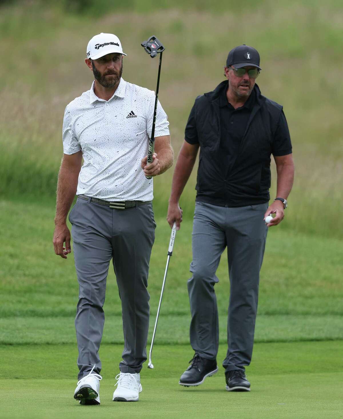 ST ALBANS, ENGLAND - JUNE 09: Dustin Johnson and Phil Mickelson of the United States pictured on the 4th green during day one of the LIV Golf Invitational at The Centurion Club on June 09, 2022 in St Albans, England. (Photo by Matthew Lewis/Getty Images)