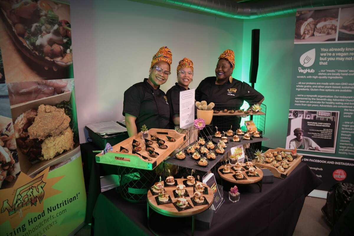 The Vegan Hood Chefs, a Bay Area food truck and catering company, stops to pose in front of their food at a past Black Food & Wine Experience evening. 