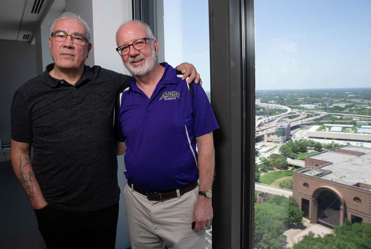 Steve Meeker, right, a Montgomery ISD teacher who just retired after 40 years, and Kerry Cook, an ex-prisoner wrongfully accused of murder, pose for a photograph in a law firm office Tuesday, June 7, 2022, in Houston. Meeker helped Cook getting his GED, which Cook said symbolized hope to him, while he was in prison.