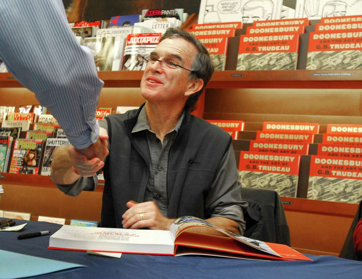 “Doonesbury” creator Gary Trudeau greets a fan at a book signing in New Haven in 2010.