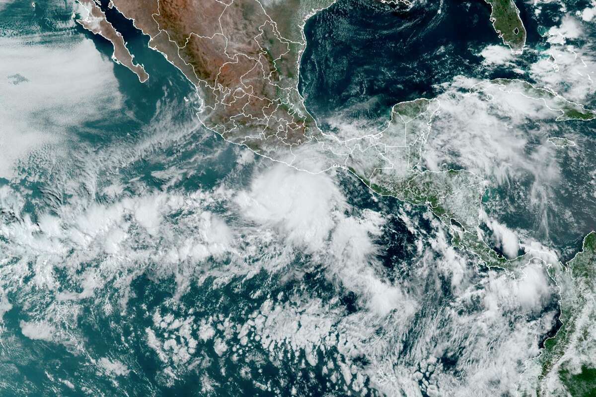 This satellite image made available by NOAA shows Hurricane Agatha, center, off the Pacific coast of Mexico on Sunday, May 29, 2022.