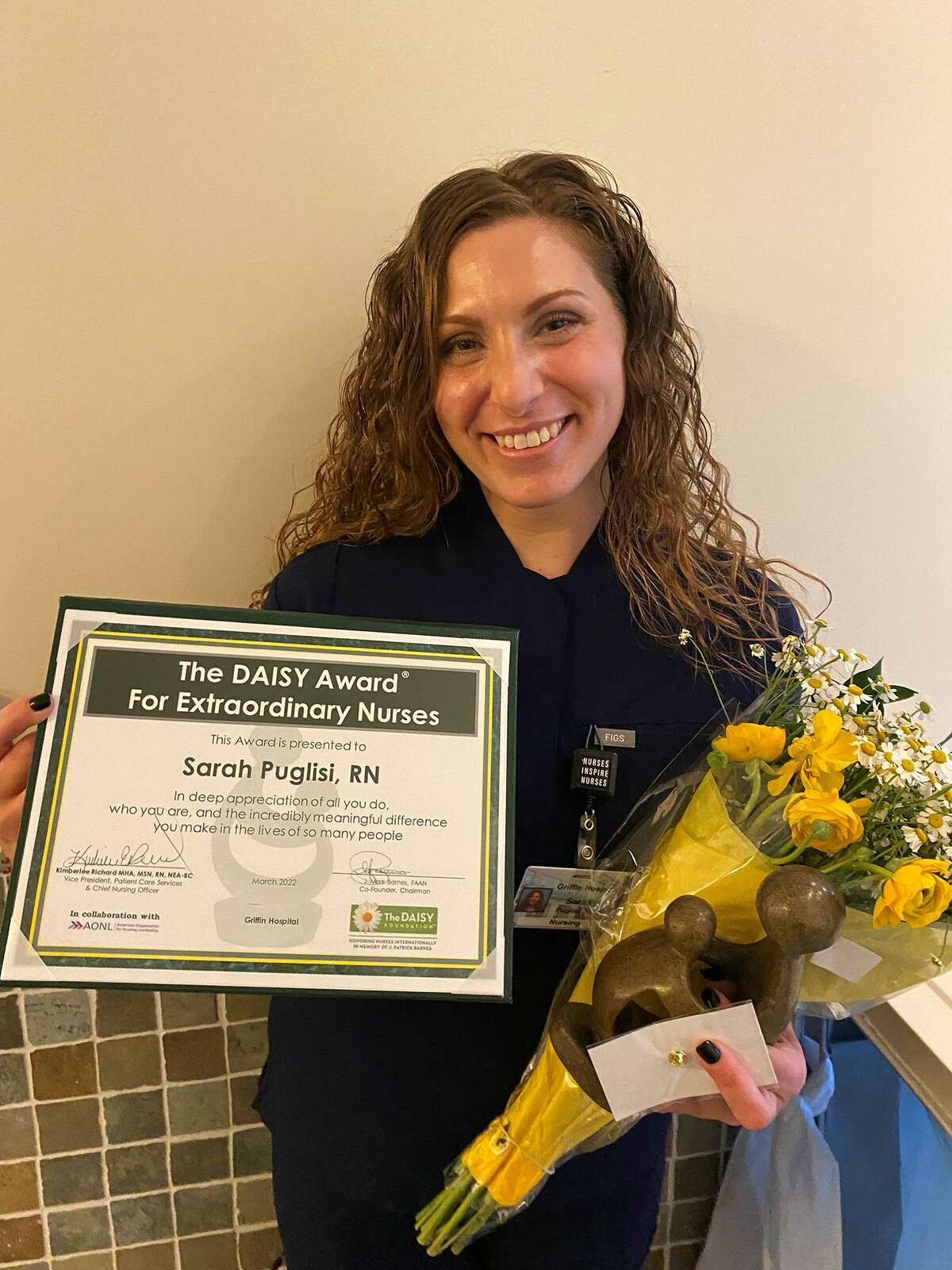 Griffin Health in Derby recently honored Tammy Piccolo, RN, and Sarah Puglisi, RN, pictured, both of Ansonia, and Susanne Festini, RN, of Shelton, with The DAISY Award for Extraordinary Nurses.
