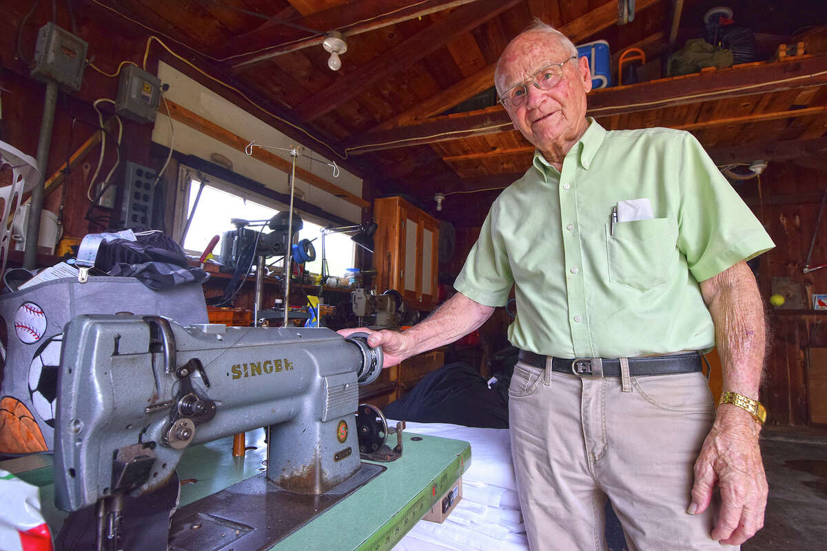 Tom Holmes, 96, repairs industrial sewing machines.  