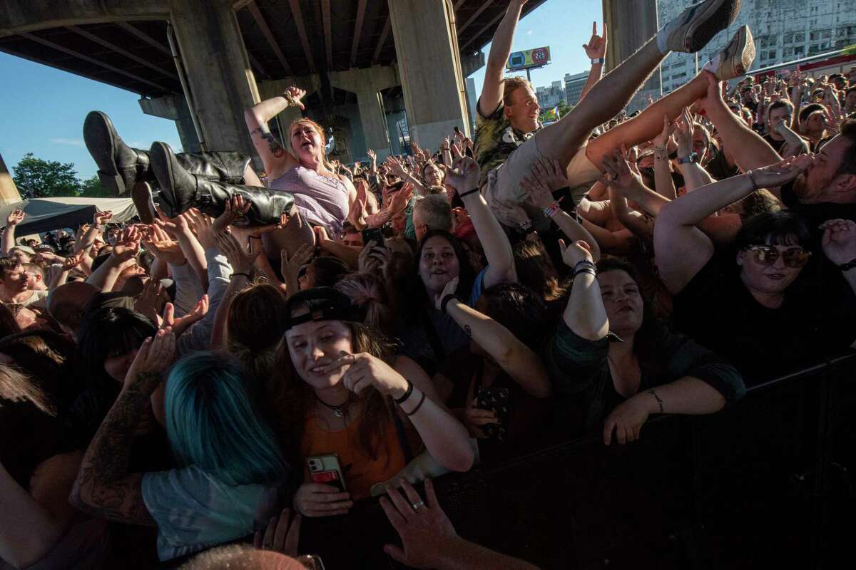 Fans body surf to the pit in front of the stage as State Champs perform during Alive at Five at the Corning Preserve on Thursday, June 9, 2022 in Albany, N.Y. Albany's eight-week Alive at 5 series of free concerts on Thursday nights at the riverfront amphitheater starts with a show by Young Culture with State Champs. The concert was held under I-787 which is the rain location.