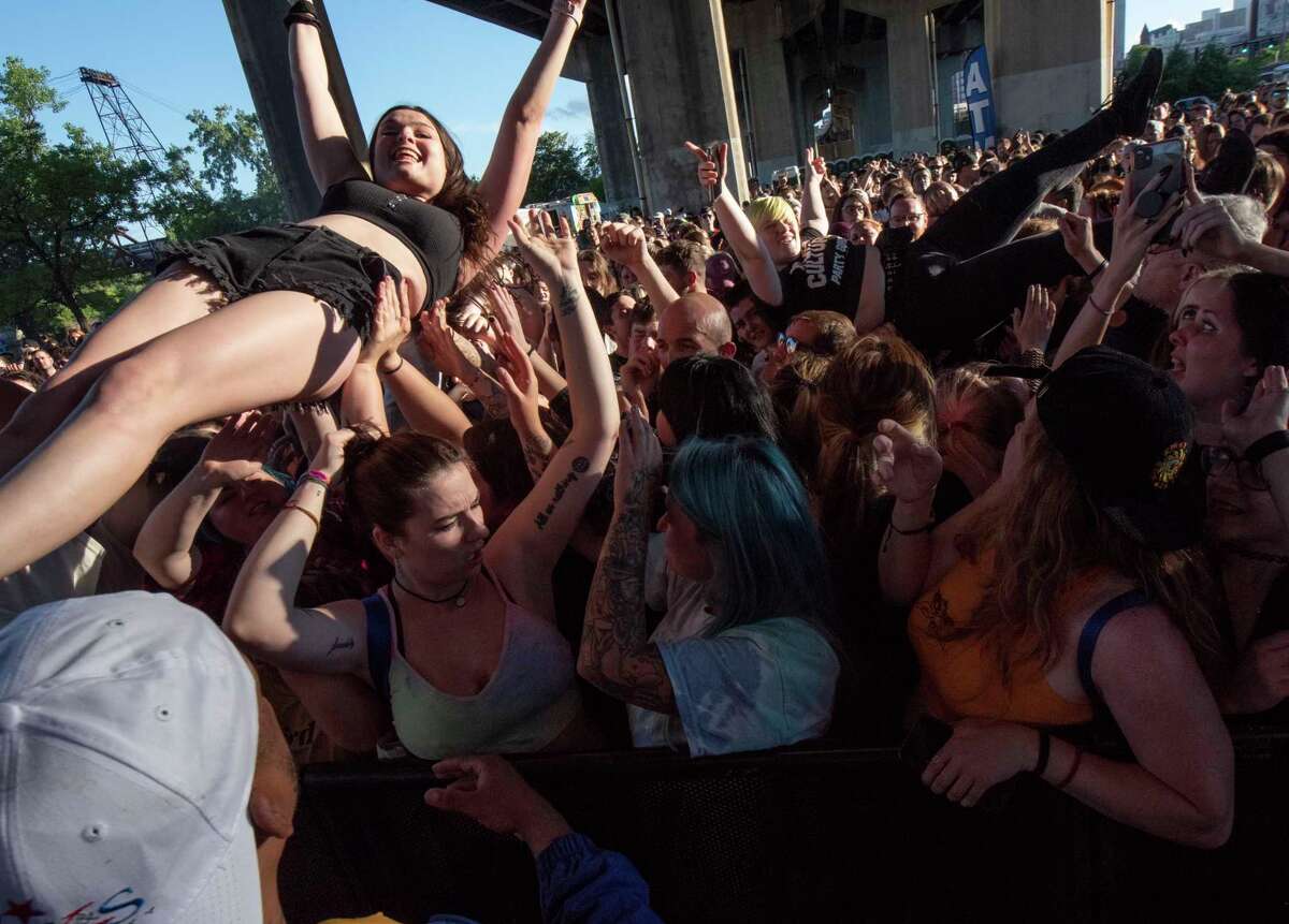 Fans body surf to the pit in front of the stage as State Champs perform during Alive at Five at the Corning Preserve on Thursday, June 9, 2022 in Albany, N.Y. Albany's eight-week Alive at 5 series of free concerts on Thursday nights at the riverfront amphitheater starts with a show by Young Culture with State Champs. The concert was held under I-787 which is the rain location.