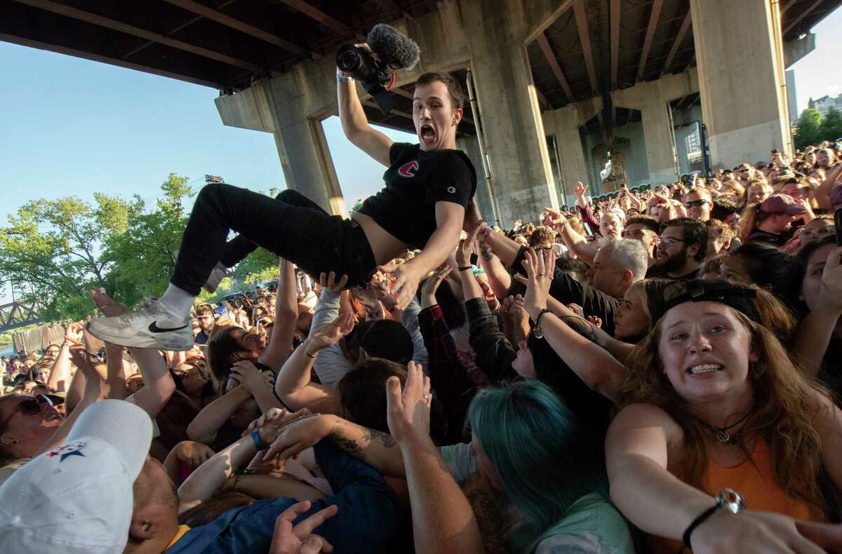 Fans body surf to the pit in front of the stage as State Champs perform during Alive at Five at the Corning Preserve on Thursday, June 9, 2022 in Albany, N.Y. Albany's eight-week Alive at 5 series of free concerts on Thursday nights at the riverfront amphitheater starts with a show by Young Culture with State Champs. The concert was held under I-787 which is the rain location.