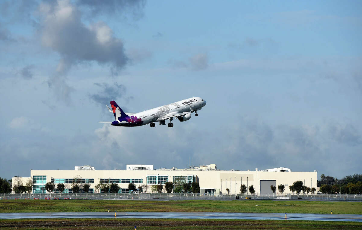 A Hawaiian Airlines aircraft takes off from Long Beach in March 2021.