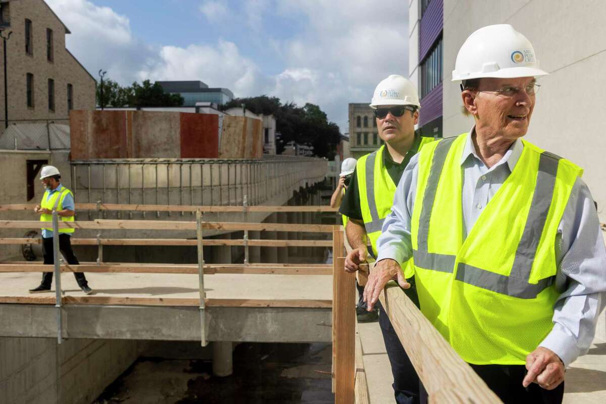 Bexar County Judge Nelson Wolff, front, and Bexar County Precinct 2 Commissioner Justin Rodriguez get updates during a tour of the latest progress of the San Pedro Creek Cultural Park in San Antonio, Texas on June 10, 2022.