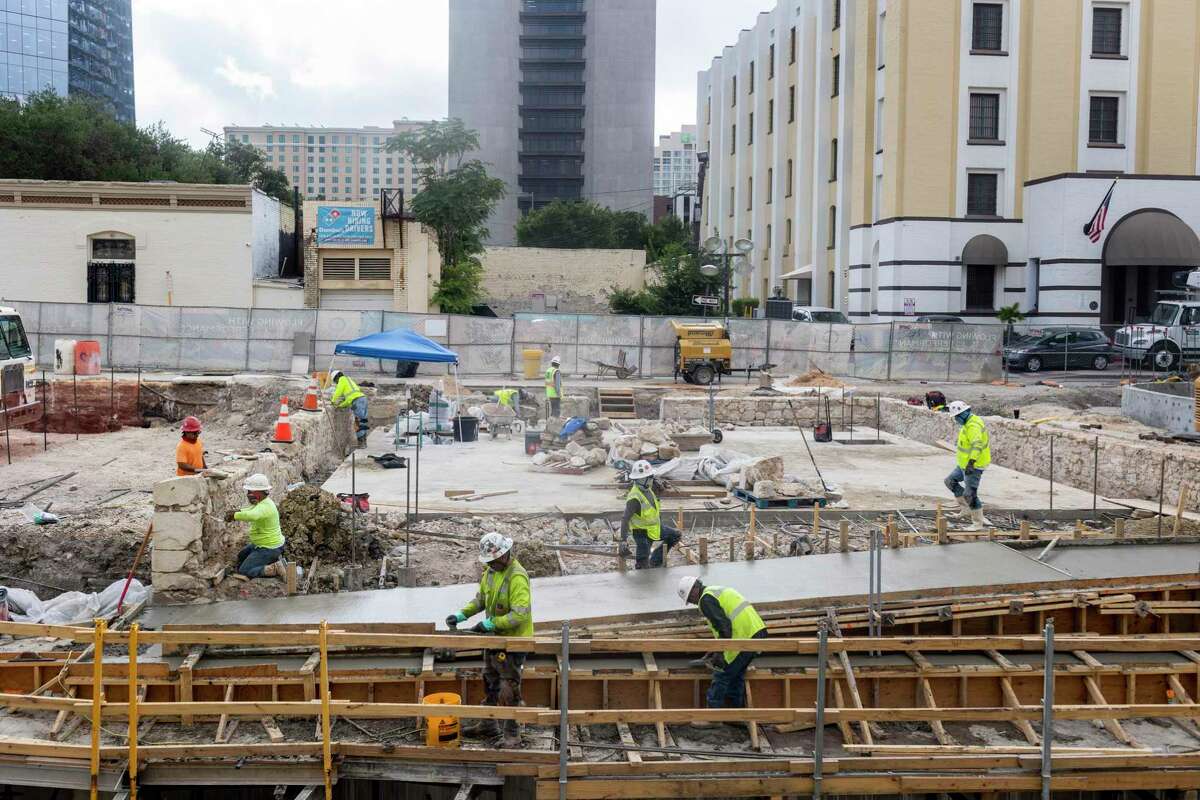 Construction crew members work on the foundation of the historic AME Church along the San Pedro Creek Cultural Park in San Antonio, Texas, on June 9, 2022.