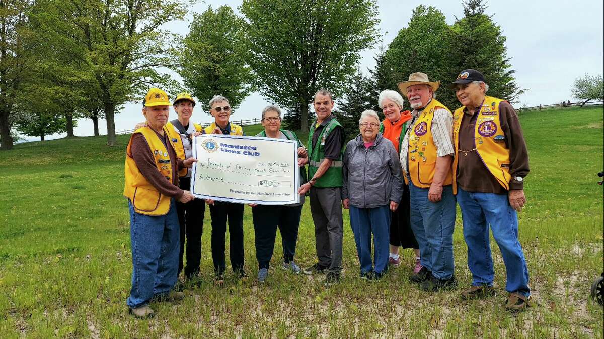 The Manistee Lions Club recently donated $400 to the Friends of Orchard Beach State Park to go toward a universally accessible playground at the park. Pictured (from left) are friends members and Lions Club members: John Mencarelli, Sue Mencarelli, Virginia Szymanski, Lorrie Manthei, Ken Lawyer, Judy Ross, Kelly Griffin, John Carter and Ted Ross.
