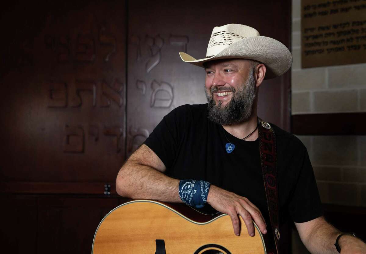 Country singer Joe Buchanan poses for a photograph at Congregation Shaar Hashalom, where he converted to Judaism, Tuesday, June 7, 2022, in Houston. Buchanan has a Jewish theme to his songs. He used songwriting to understand the new-to-him religious tenets.