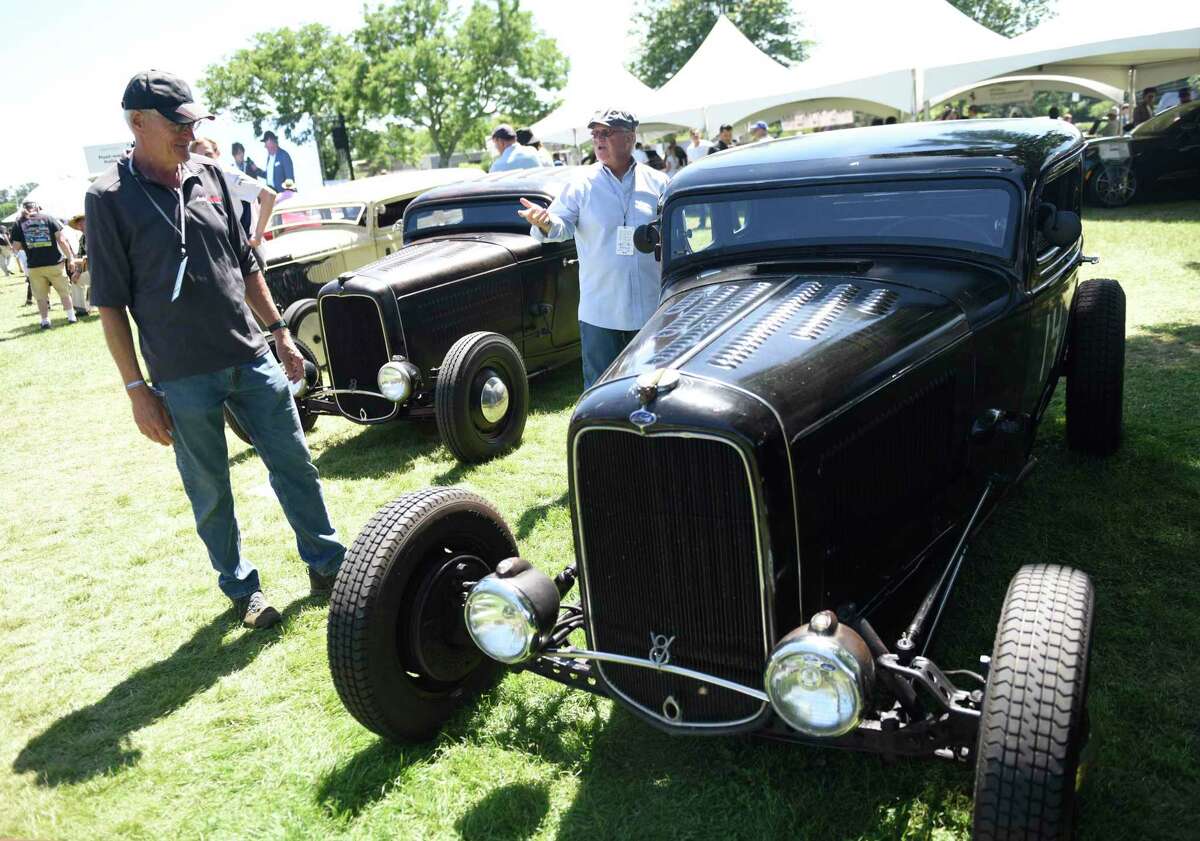 Visitors enjoy the Greenwich Concours d’Elegance car show at Roger Sherman Baldwin Park in Greenwich, Conn. Sunday, June 5, 2022. The multiday event featured hundreds of cars in a variety of categories on display, speakers, awards, kids events, food, and more.