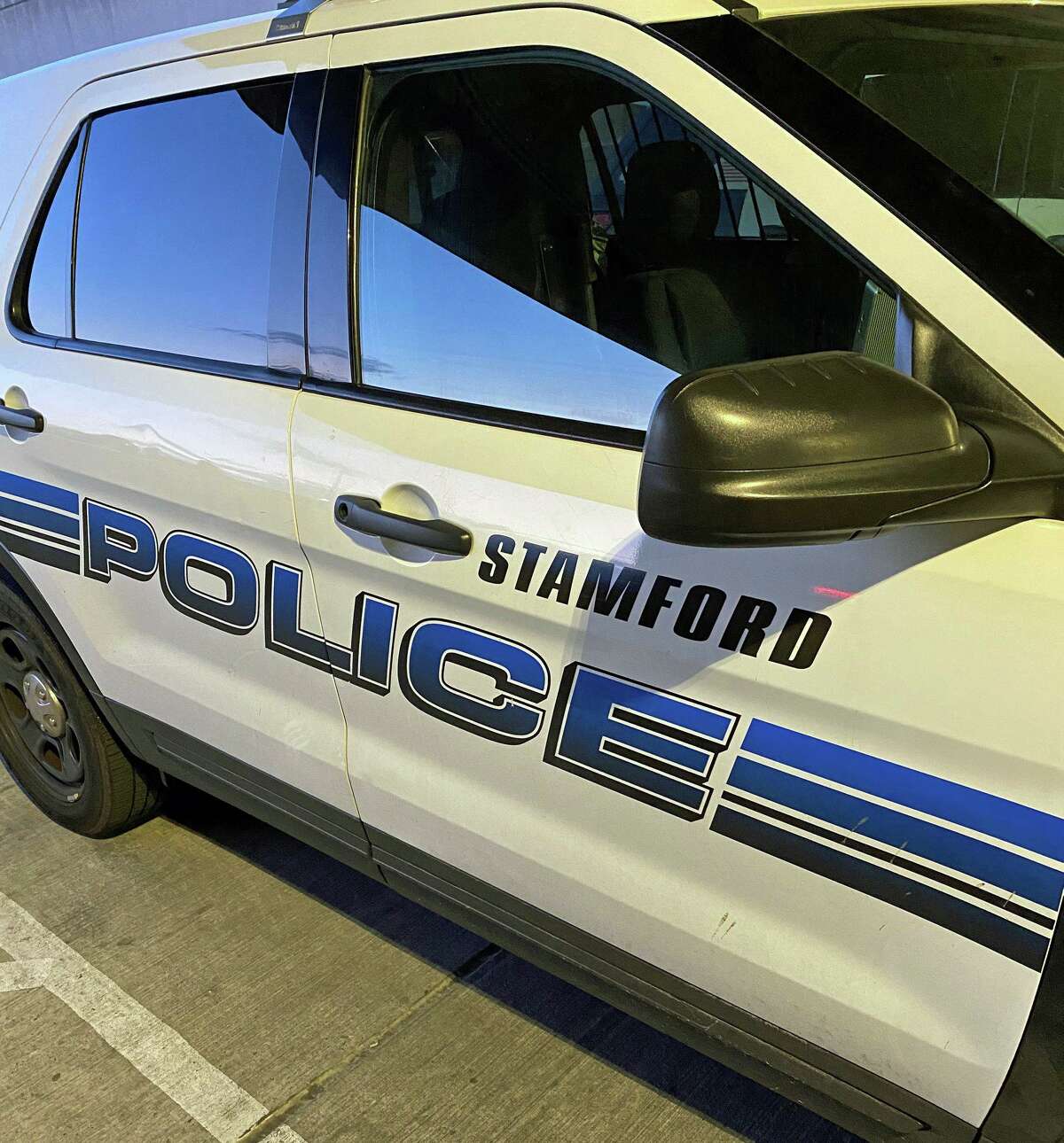 A Stamford police cruiser. A car attempting to turn left in downtown Stamford sent a motorcyclist to the hospital with serious injuries Friday afternoon, according to police.
