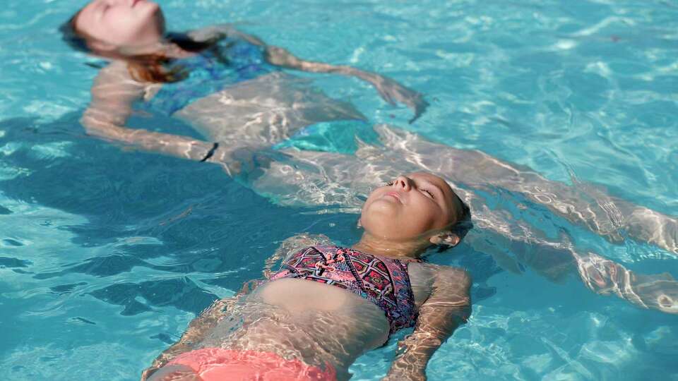 Abigail Randall, bottom, works on her floating as more than 100 youth from around Montgomery County took part in the 2021 World's Largest Swimming Lesson at the City of Conroe Water Park, Friday, June 18, 2021, in Conroe. The WLSL event occurs once a year where participating groups take part in the same swim lesson across 48 countries. Since beginning in 2010, the event has reached 320,000 people and serves as a platform to help the global aquatics industry work together to build awareness about the fundamental importance of teaching children to swim to prevent drowning. This year's event is set for June 24.