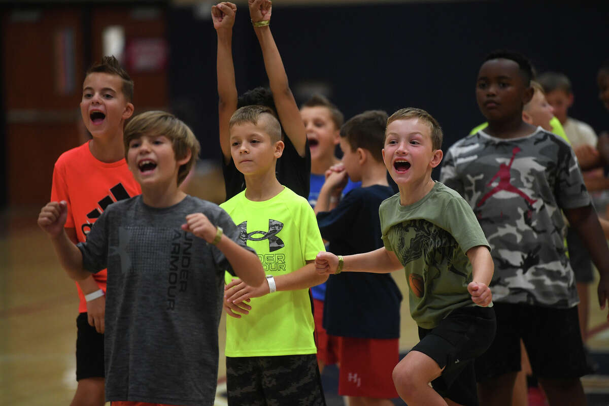 Kids react as others score while practicing their shooting during a summer basketball camp at Hardin-Jefferson High School last week. Photo made Thursday, June 9, 2022. Kim Brent/The Enterprise