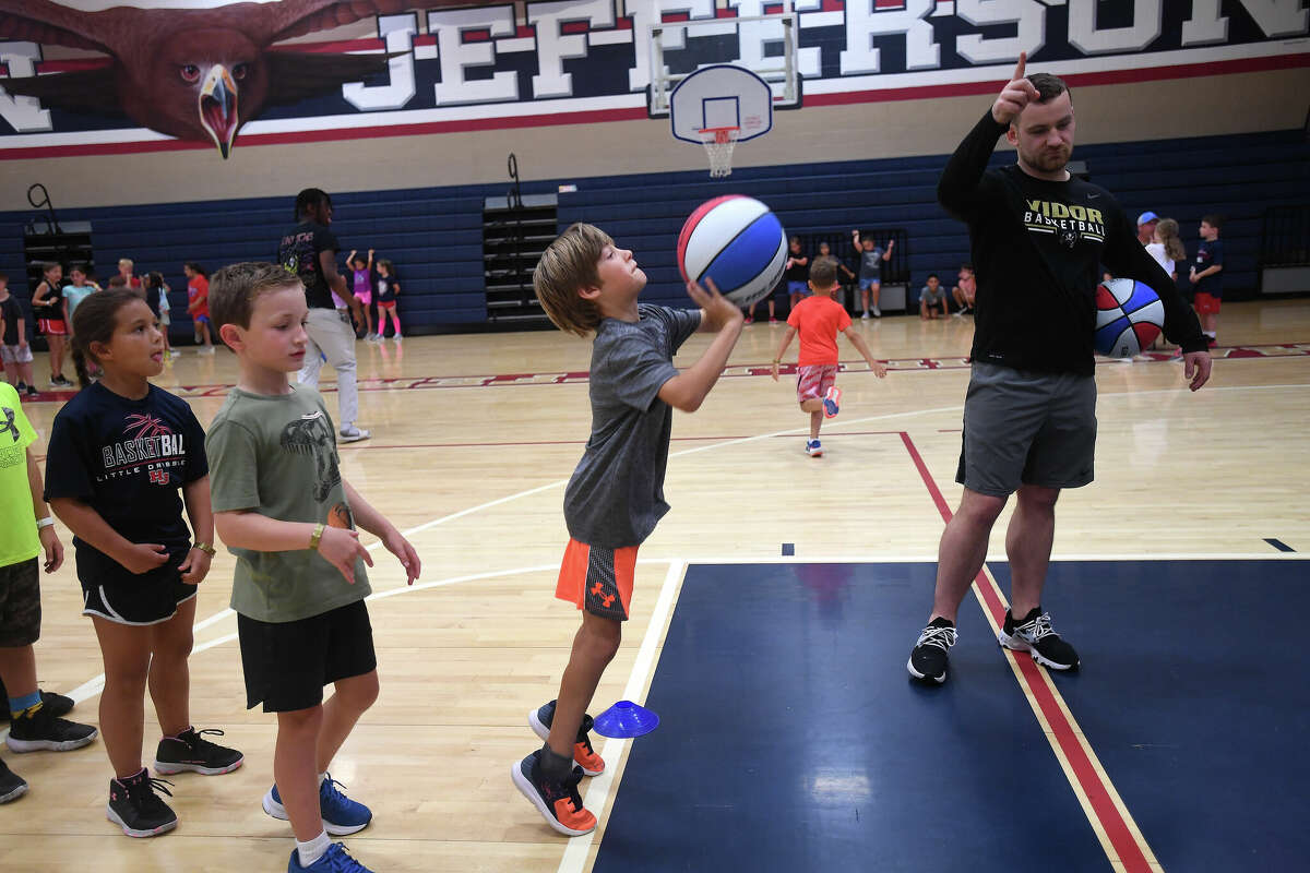 Kids practice their shooting from there throw line during a summer basketball camp at Hardin-Jefferson High School last week. Photo made Thursday, June 9, 2022. Kim Brent/The Enterprise