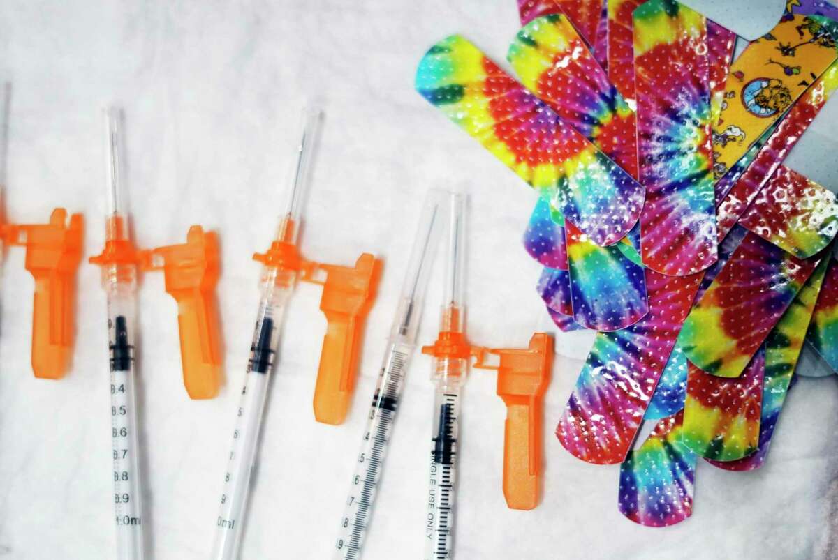 Syringes and colorful bandages are prepared for children getting COVID-19 vaccines. FDA advisers have recommended authorizing the Moderna shot for youth ages 6 to 17.