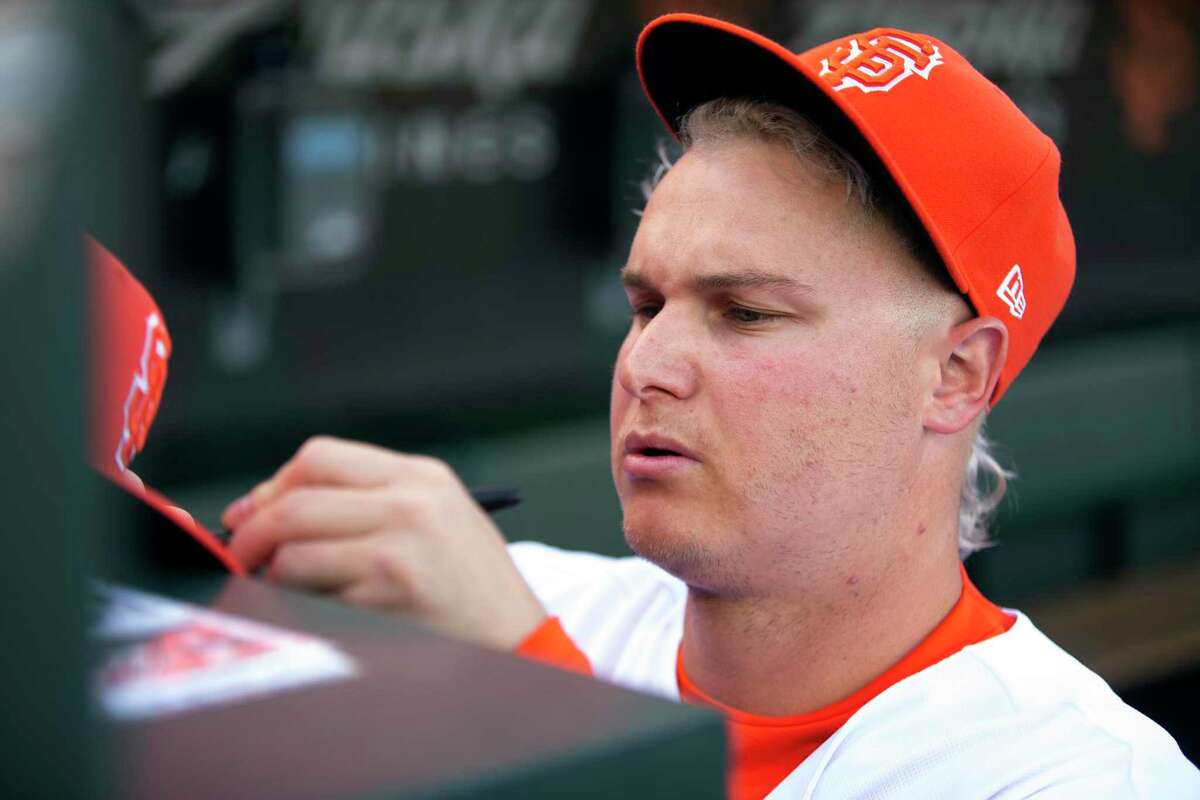 San Francisco Giants left fielder Joc Pederson signs autographs before the team's baseball game against the Colorado Rockies, Tuesday, June 7, 2022, in San Francisco. (AP Photo/D. Ross Cameron)