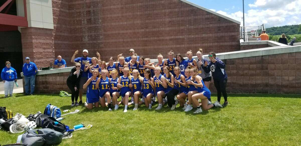 The Queensbury girls' lacrosse team gets together for a team photo after edging Westhampton Beach in the state semifinals on Friday, June 10, 2022.