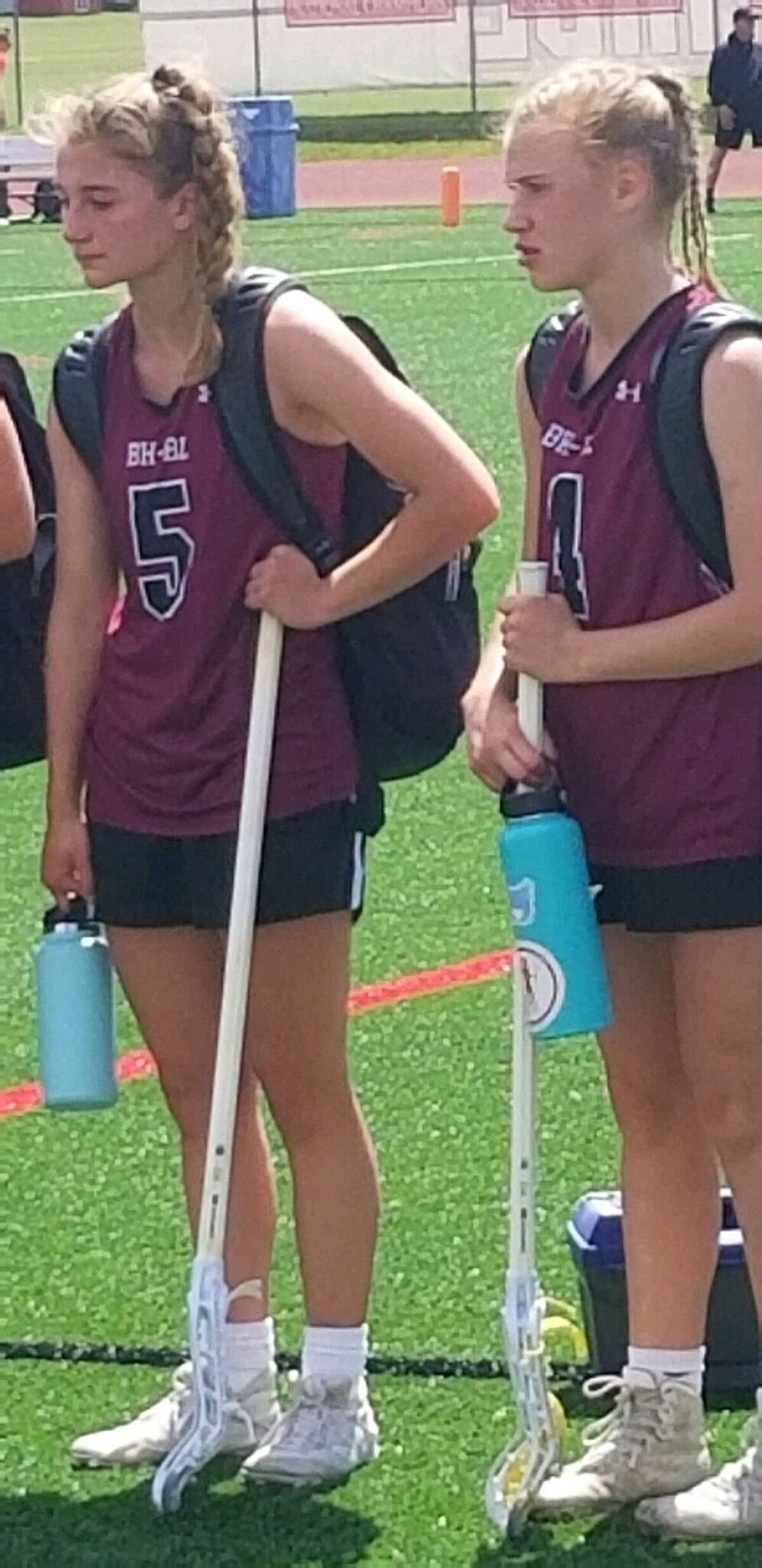 Ella Blesi, left, and Maggie Lescault of Burnt Hills react during the awards ceremony after falling in the Class C girls' lacrosse state semifinals on Friday.