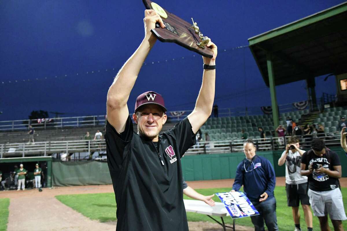 Windsor coach Joe Serfass lifts the state championship plaque after Windsor beat Maloney, 3-1, in the Class L baseball championship at Palmer Field, Middletown on Friday,, June 10, 2022.