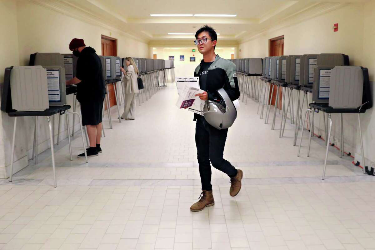 Eric Chang prepares to vote a nearly empty poll location at San Francisco City Hall on Tuesday.