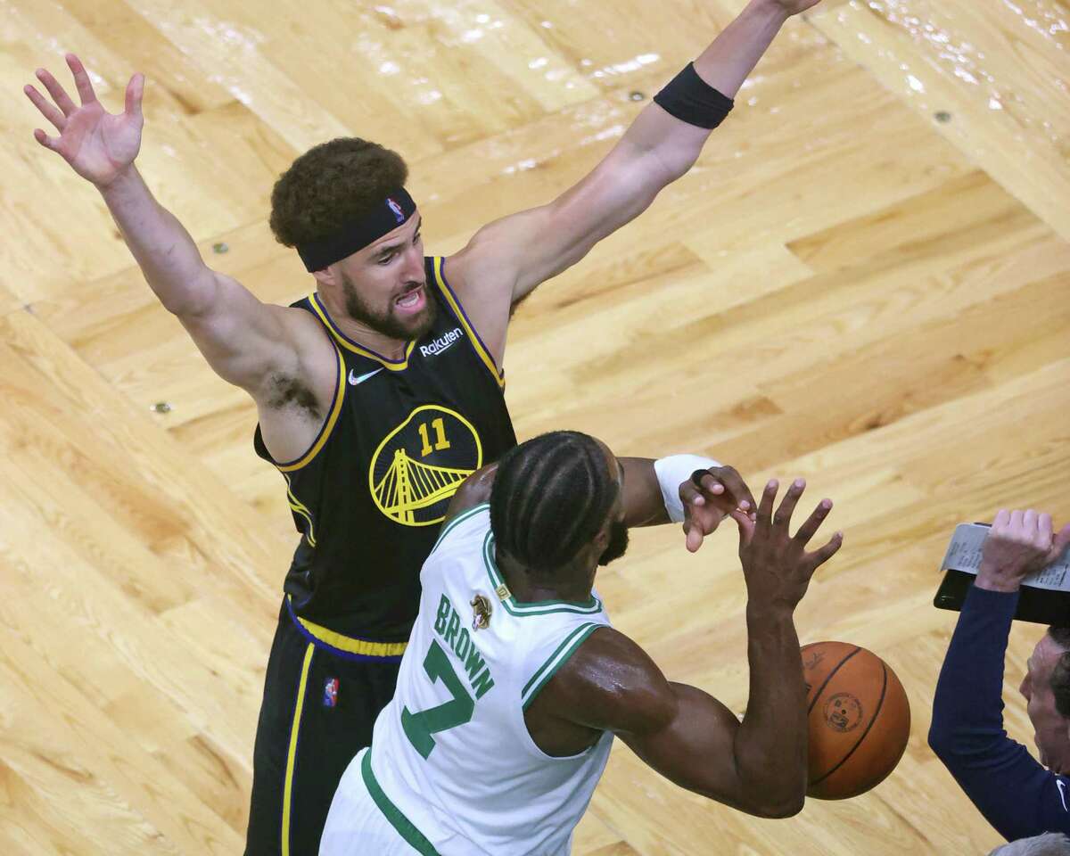 Golden State Warriors’ Klay Thompson forces a turnover by Boston Celtics’ Jaylen Brown late in 4th quarter of Warriors’ 107-97 win in Game 4 of NBA Finals at TD Garden in Boston, Mass., on Friday, June 10, 2022.