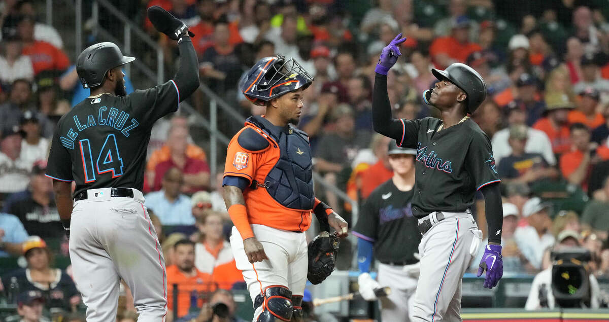 Miami Marlins Jazz Chisholm Jr. (2) celebrates with Bryan De La Cruz (14) after hitting a two-run home run off of Houston Astros starting pitcher Luis Garcia during the fifth inning of an MLB game at Minute Maid Park on Friday, June 10, 2022 in Houston.
