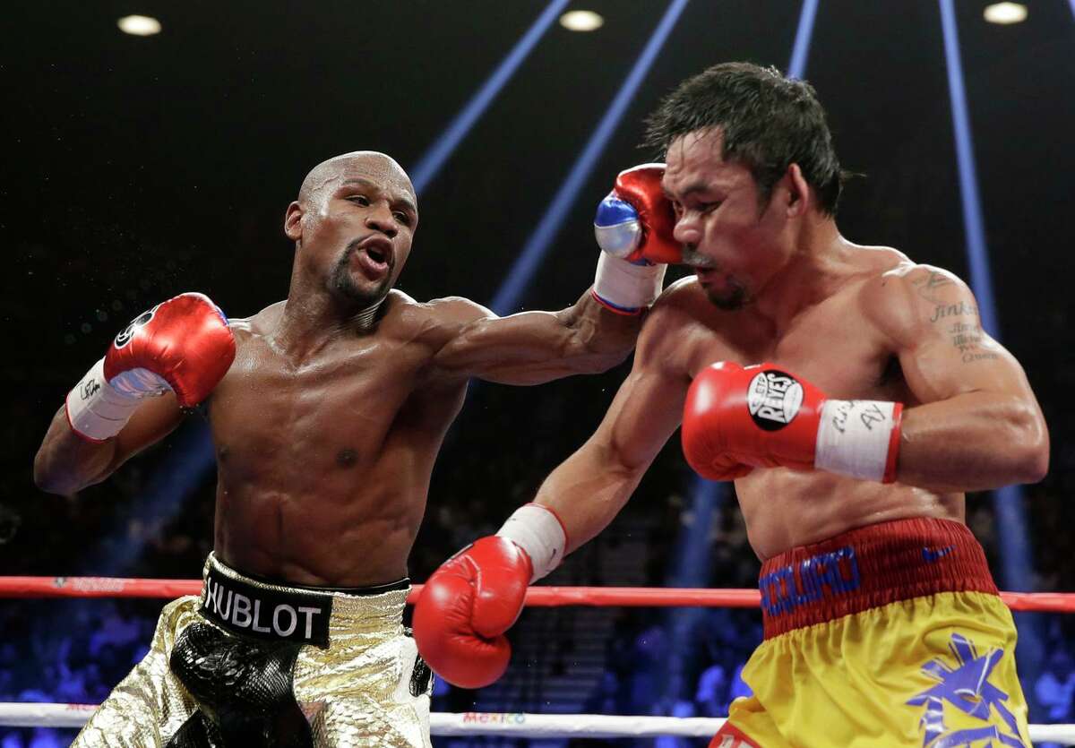 Floyd Mayweather Jr. (left), set to be inducted into the International Boxing Hall of Fame, earned about $200 million in his welterweight fight against Manny Pacquiao in 2015.