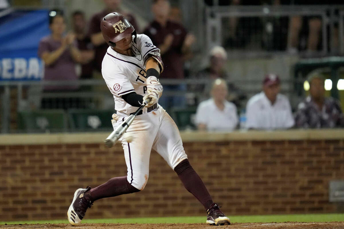 Texas A&M's Troy Claunch hits a single that drove in the winning run against Louisville during an NCAA college baseball super regional tournament game early Saturday, June 11, 2022, in College Station, Texas. (AP Photo/Sam Craft)