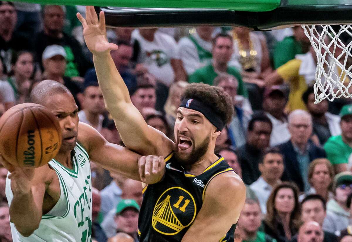 KlayThompson (11) defends against Al Horford (42) in the first half as the Golden State Warriors played the Boston Celtics in Game 4 of the NBA Finals at TD Garden in Boston, Mass., on Friday, June 10, 2022. The Warriors won 107-97 to tie the series at 2-2.