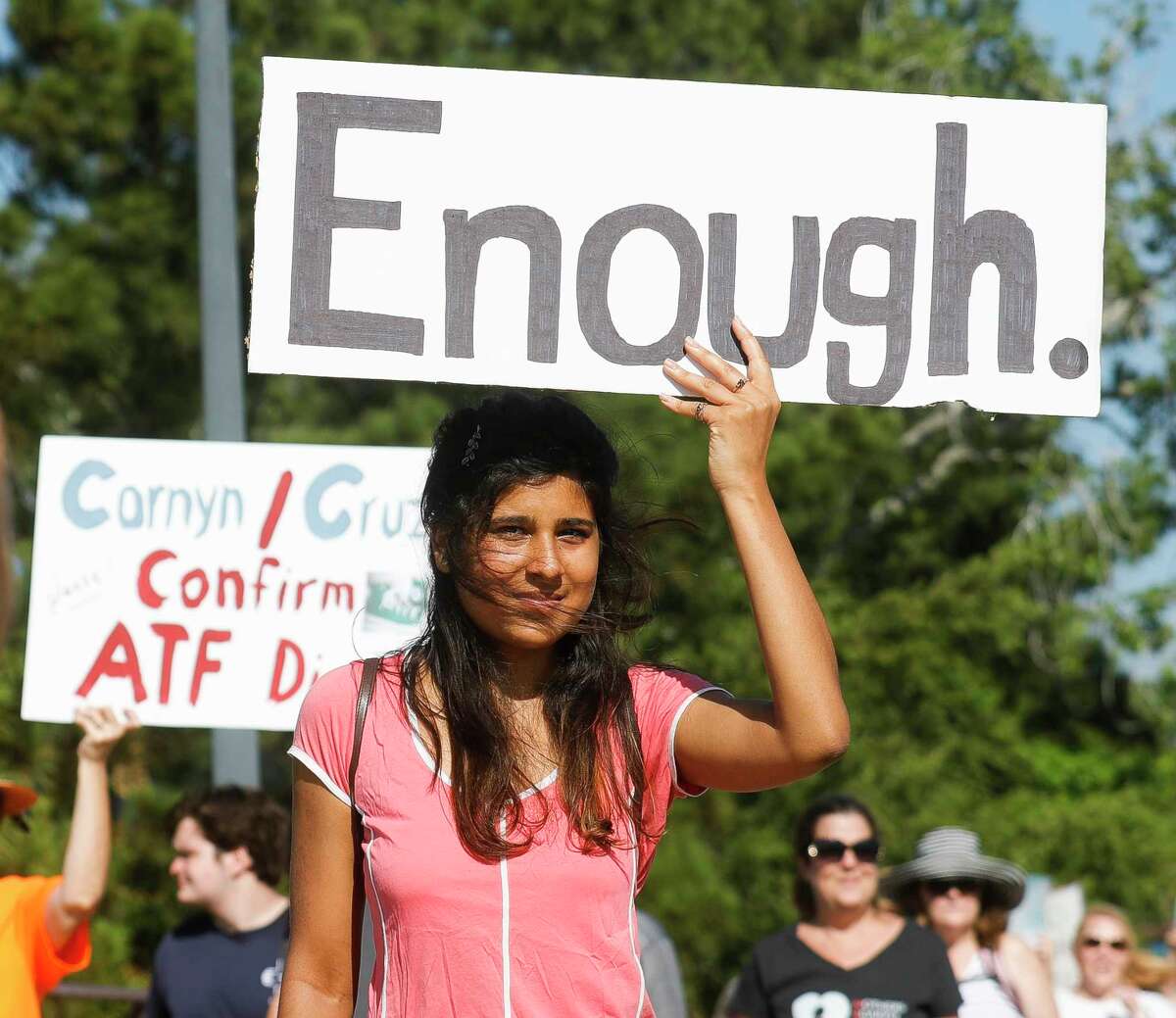 A protester hold a sign that reads “Enough” during a March for Our Lives rally at Northshore Park, Saturday, June 11, 2022, in The Woodlands. The organization held more than a dozen rallies statewide this weekend in response to the mass shooting at a Uvalde elementary school where 19 children and two teachers were shot to death. March for Our Lives started in 2018 following the shooting at Majory Stoneman Douglas High School in Parkland, Fla., and rallies in support of new gun safety laws.