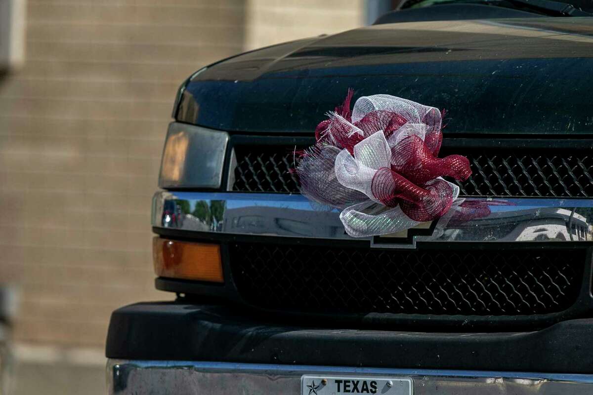 A maroon and white ribbon decorates the grill of a car driving through Uvalde on Saturday, June 11, 2022.