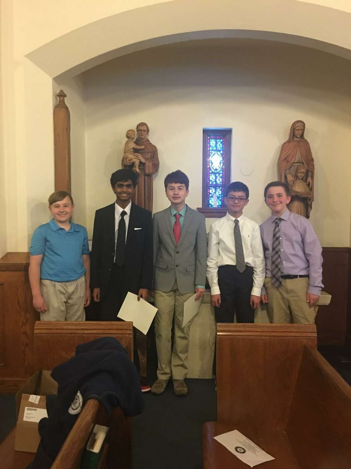 St. Mary School inducted 15 new members into the National Junior Honor Society - St. Mary School Milford Chapter in St. Mary Church of Precious Blood Parish on April 28, 2022.