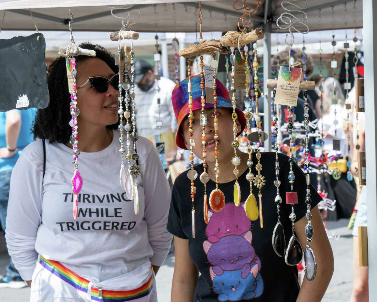 Tibisay Hernandez and her daughter, Mia Luke, check out the wares during the Art on Lark street festival held on Lark Street on Saturday, June 11, 2022. (Jim Franco/Special to the Times Union)