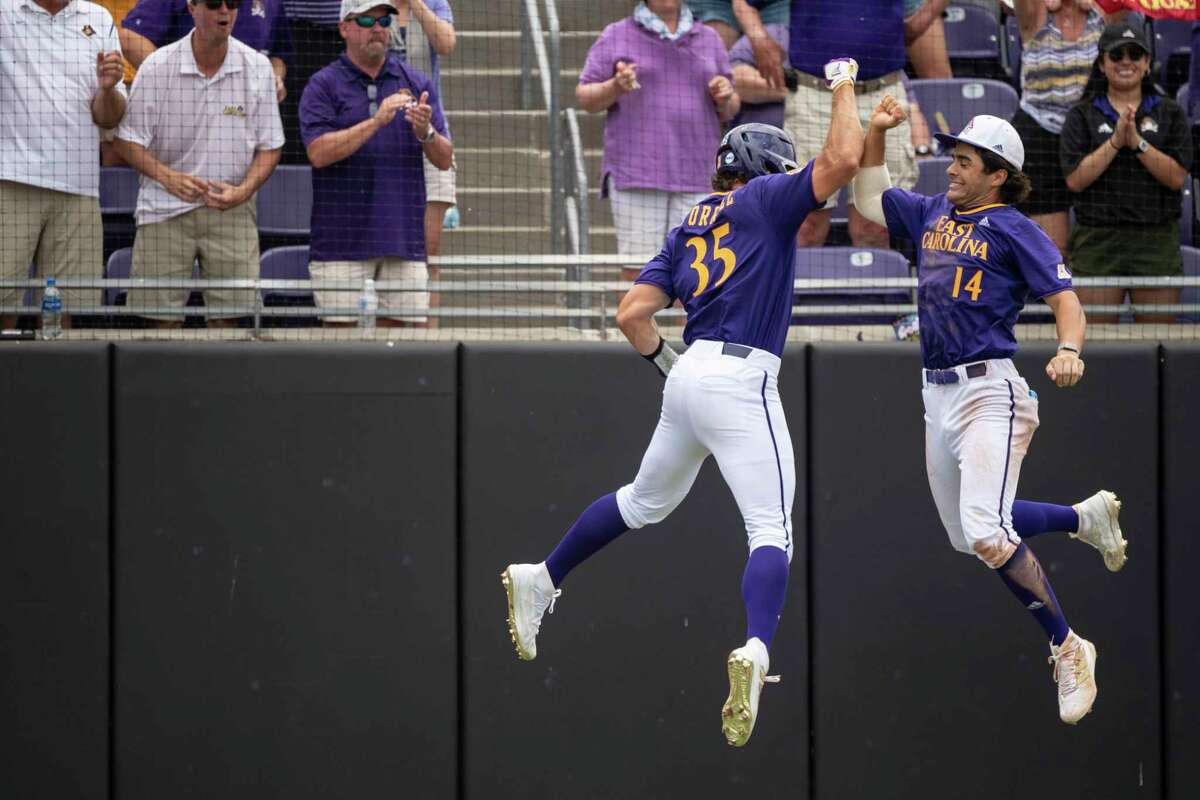 RETRANSMISSION TO CORRECT INNING TO FOURTH - East Carolin's Bryson Worrell and Zach Agnos celebrate a home run during the fourth inning of an NCAA college super regional baseball game against Texas on Saturday, June 11, 2022, in Greenville, N.C. (AP Photo/Matt Kelley)