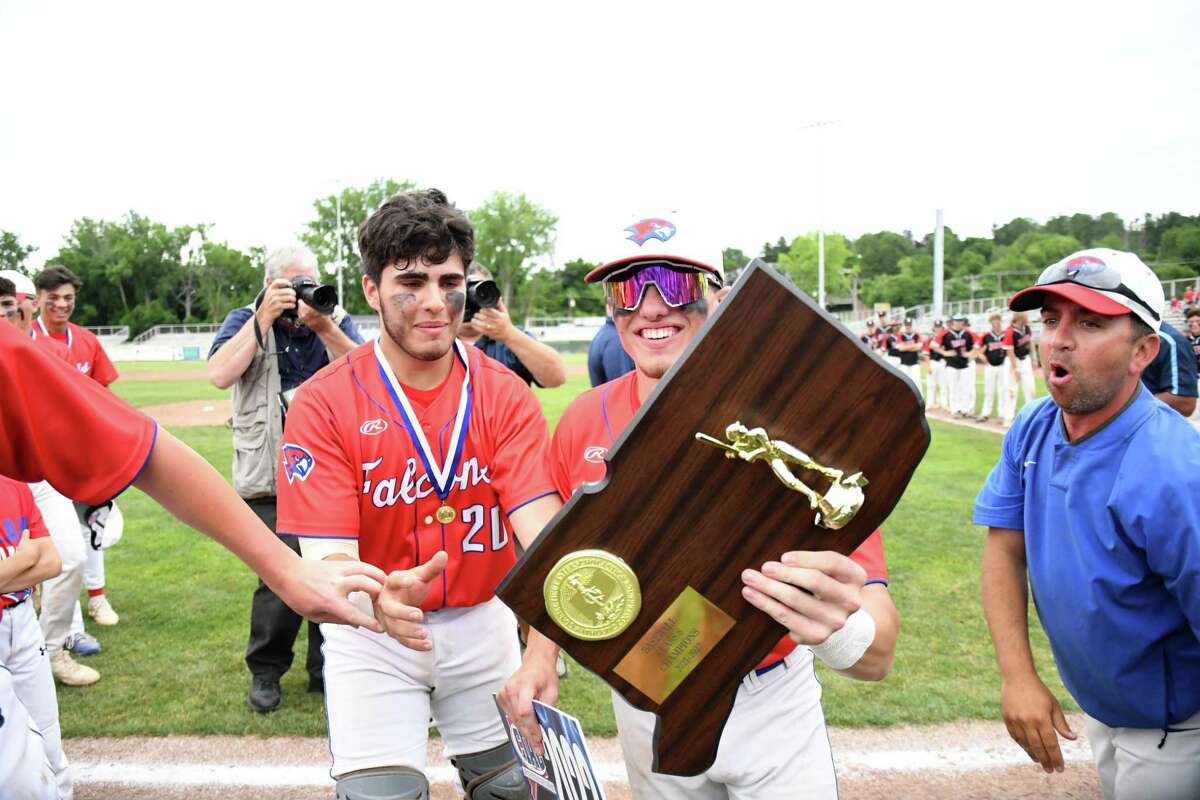 St. Paul's Ryan Daniels and Casey Cerruto grab the championship plaque after St. Paul beat Somers, 5-0 in the Class S baseball championship game at Palmer FIeld, Middletown on Saturday, June 11, 2022.