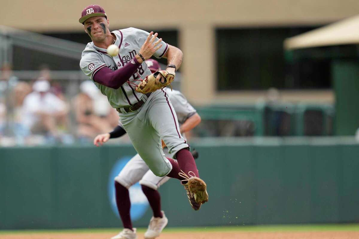 Texas A&M infielder Trevor Werner (28) fields and throws the ball to first for an out against Louisville during an NCAA college baseball super regional tournament game Saturday, June 11, 2022, in College Station, Texas. (AP Photo/Sam Craft)