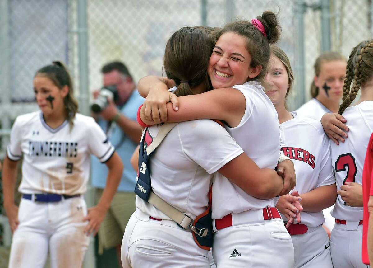 Cromwell's Caroline Voccio, right, hugs catcher Victoria Wiatrak after Saturday’s win over North Branford in the Class S championship game in Stratford.