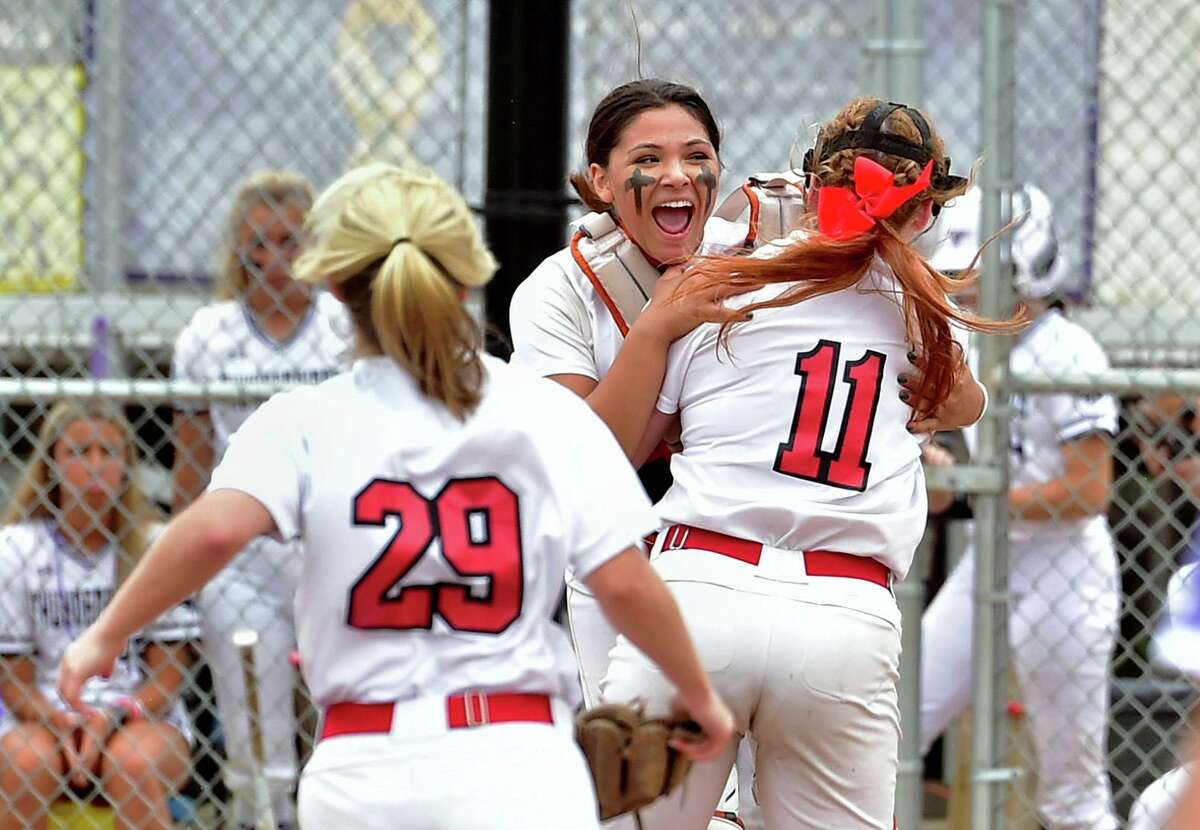 Cromwell catcher Victoria Wiatrak, facing camera, and pitcher Lily Kenney (11) embrace after the team defeated North Branford in CIAC Class S state championship softball game action at DeLuca Field in Stratford, Conn., on Saturday June 11, 2022.