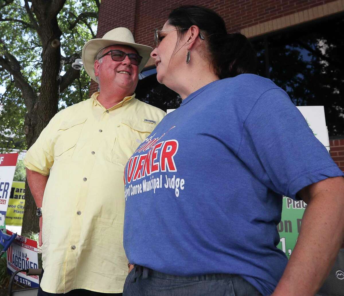 Harry Hardman, candidate for Conroe City Council Place 3, laughs with Meloney Turner, candidate for Conroe Municipal Judge, on Election Day, Saturday, June 11, 2022, in Conroe.