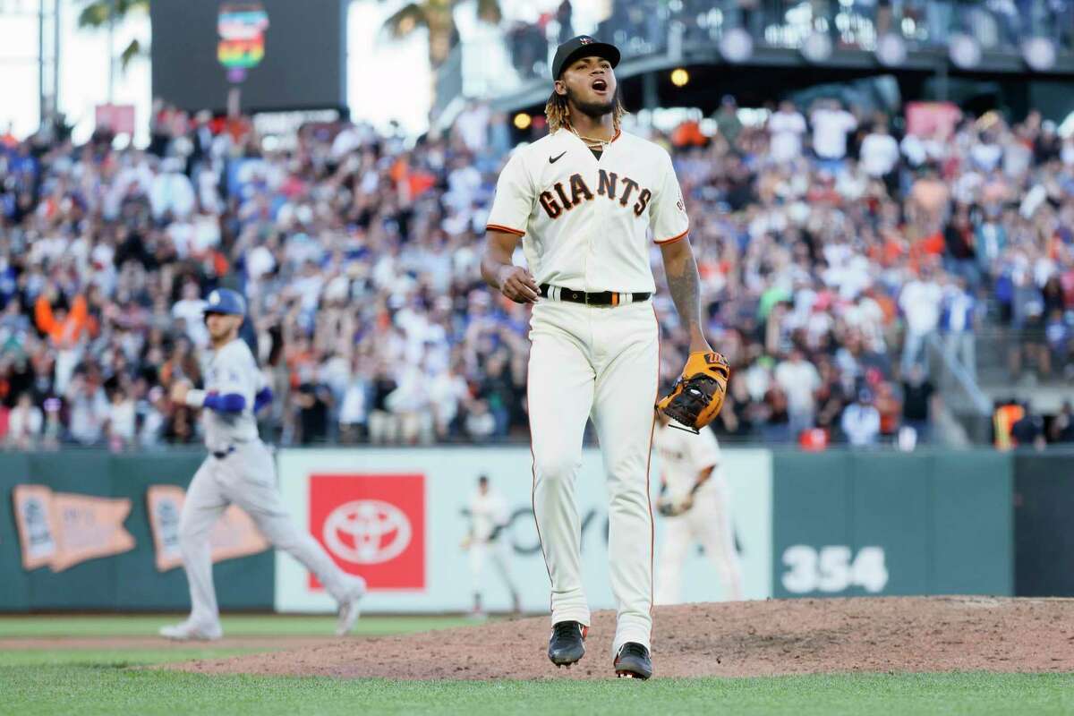 San Francisco Giants relief pitcher Camilo Doval (75) celebrates after striking out the Los Angeles Dodgers’ Mookie Betts (50) to end the top of the eighth inning with the bases loaded in an MLB game at Oracle Park, Saturday, June 11, 2022, in San Francisco, Calif.