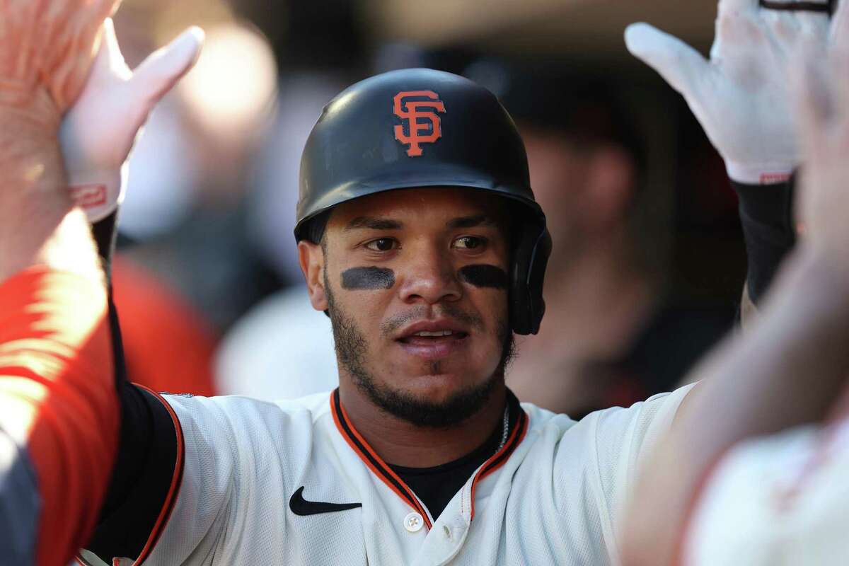 SAN FRANCISCO, CALIFORNIA - JUNE 11: Thairo Estrada #39 of the San Francisco Giants celebrates with teammates in the dugout after hitting a solo home run in the bottom of the second inning against the Los Angeles Dodgers at Oracle Park on June 11, 2022 in San Francisco, California. (Photo by Lachlan Cunningham/Getty Images)