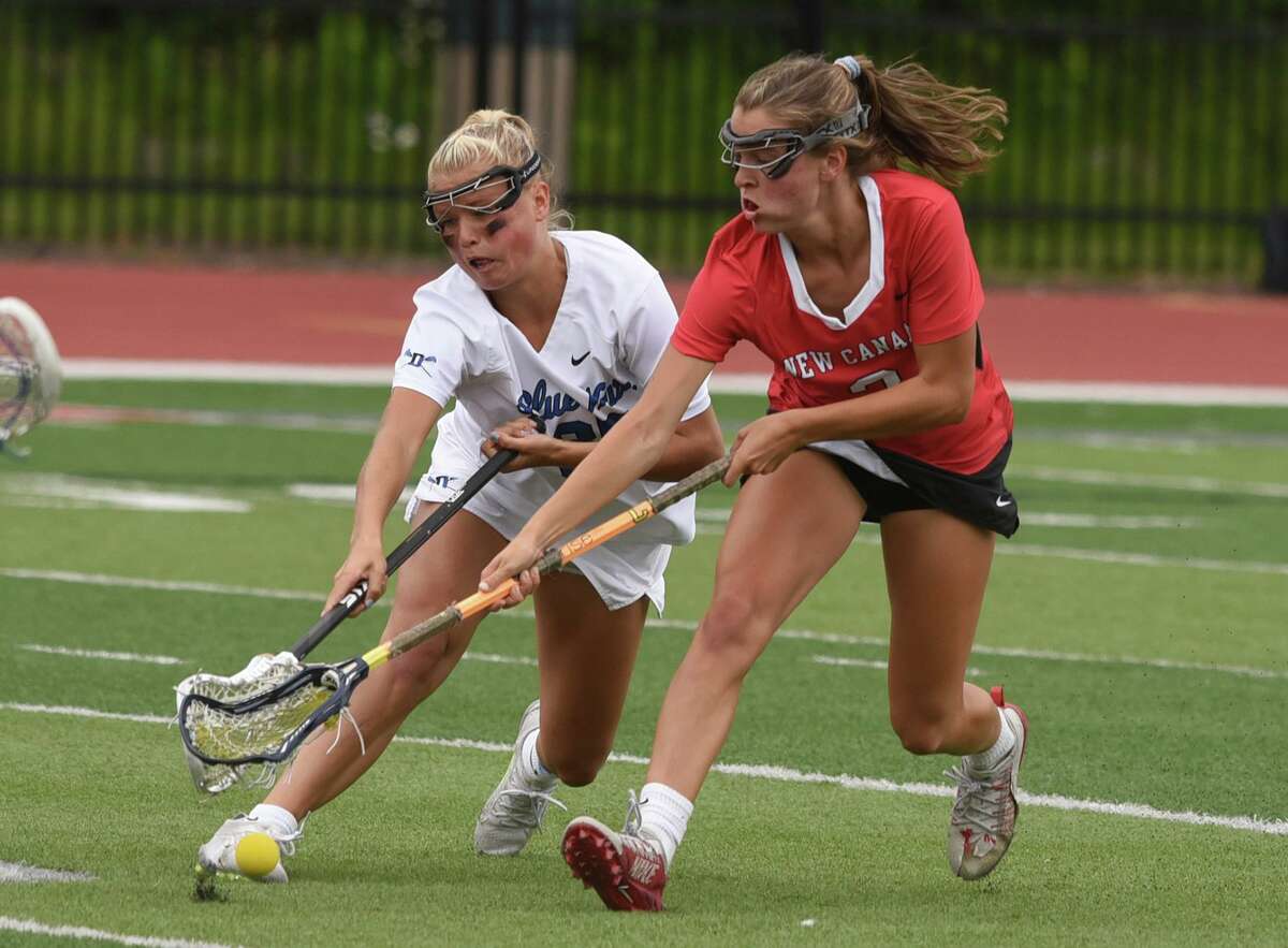 Darien's Molly McGuckin (85) and New Canaan's Dillyn Patten (3) battle for a ground ball during the CIAC Class L girls lacrosse final at Sacred Heart University on Saturday, June 11, 2022.