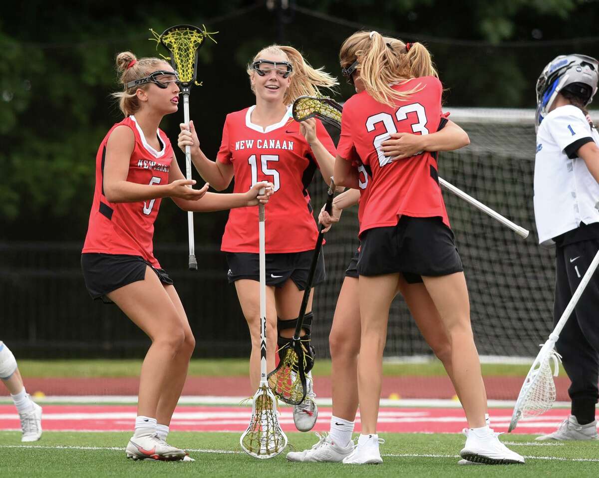 The Rams, including Stella Nolan (5), Caitlin Tully (15) and Lexie Tully (23) celebrate a New Canaan goal during the CIAC Class L girls lacrosse final against Darien at Sacred Heart University on Saturday, June 11, 2022.