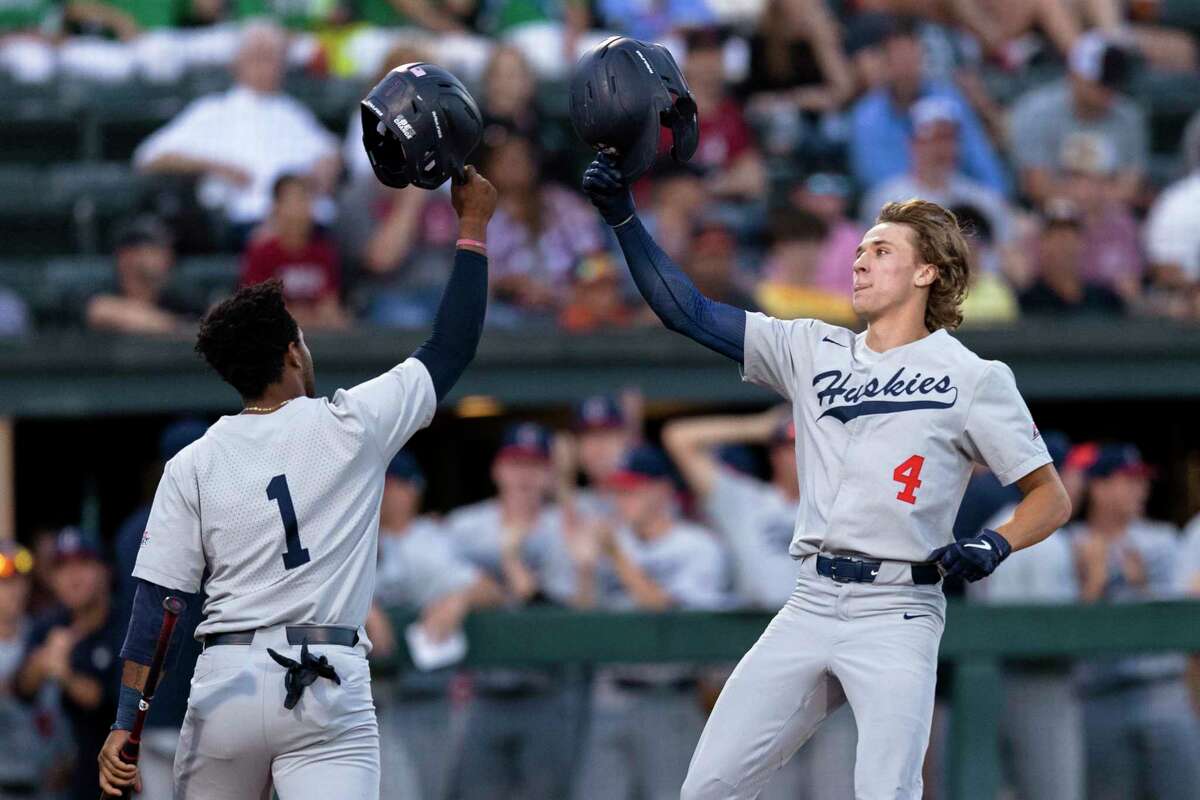 Connecticut's Korey Morton (4) celebrates with Bryan Padilla (1) after hitting a two-run home run against Stanford during the second inning of an NCAA college baseball tournament super regional game Saturday, June 11, 2022, in Stanford, Calif. (AP Photo/John Hefti)
