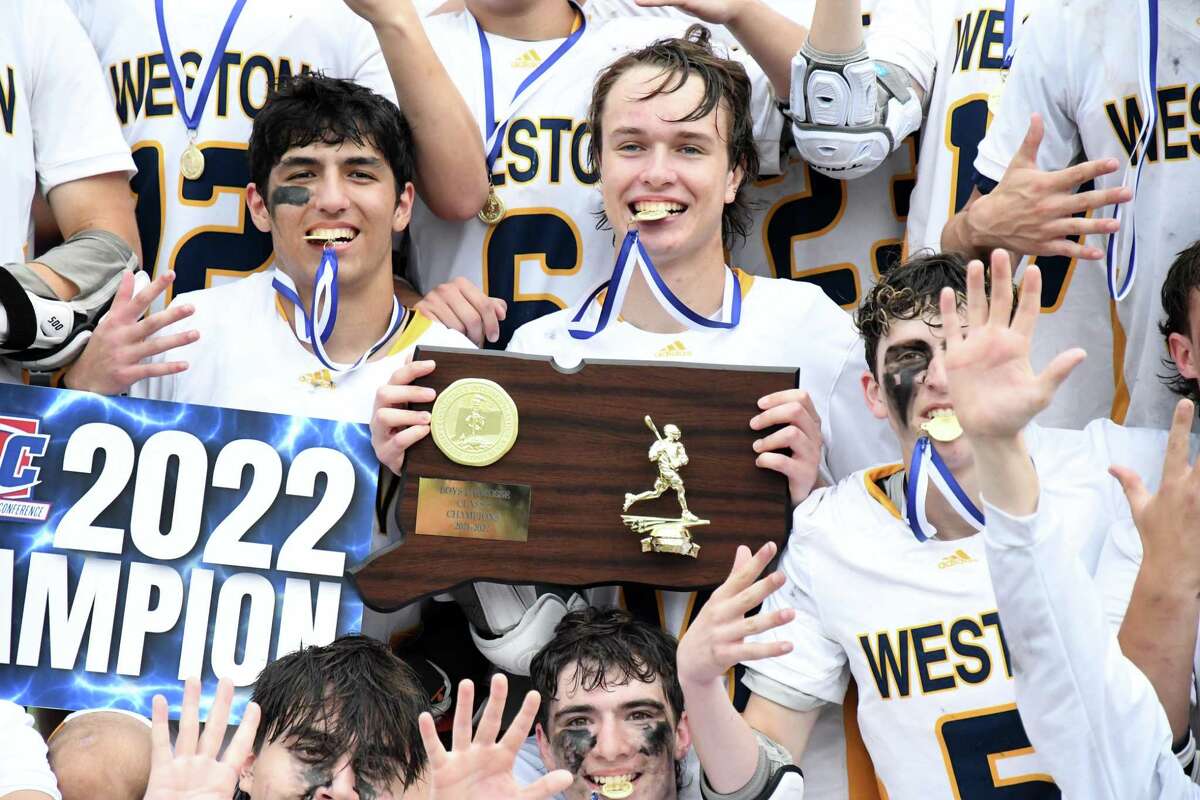 Weston celebrates its state championship after Weston defeated Northwest Catholic, 16-3, in the Class S boys lacrosse championship game at Campus Field at Sacred Heart University, Fairfield on Sunday, June 12, 2022.