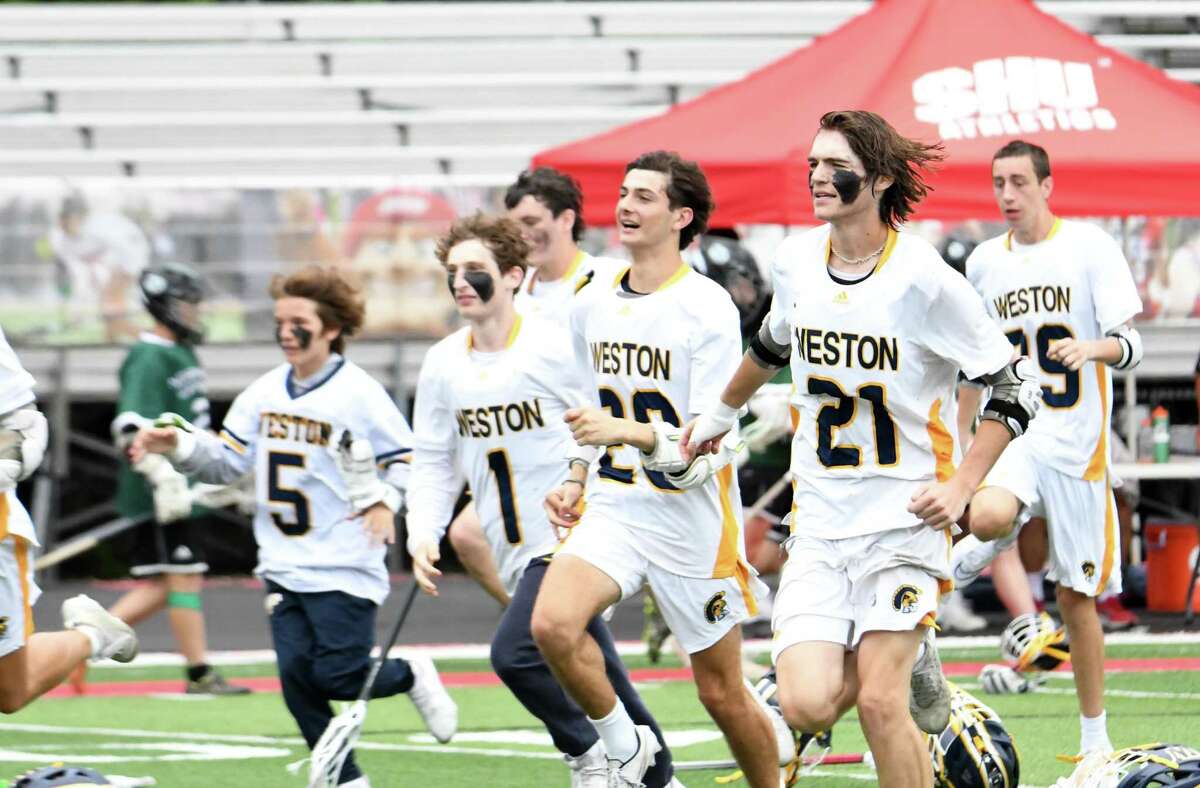 Weston celebrates its state championship after Weston defeated Northwest Catholic, 16-3, in the Class S boys lacrosse championship game at Campus Field at Sacred Heart University, Fairfield on Sunday, June 12, 2022.